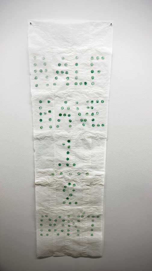 paper scroll featuring custom tyepface made with penny rubbings